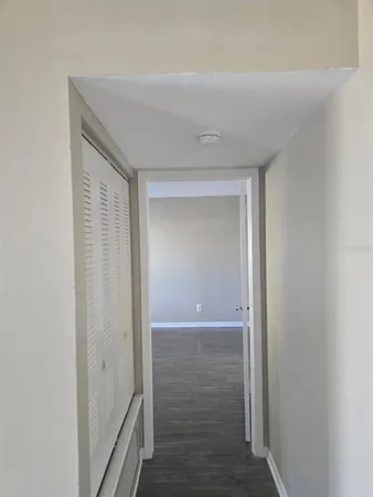 a view of hallway with wooden floor
