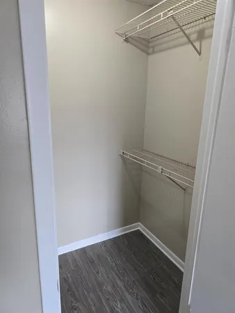 a view of a room with wooden floor