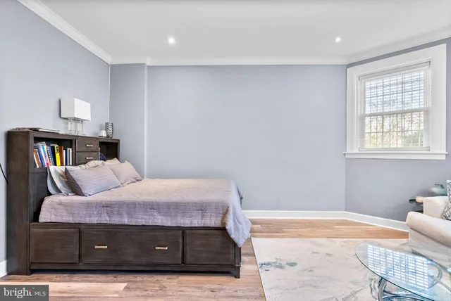 a bedroom with a bed and a book shelf