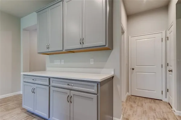 a kitchen with a sink and a hard wood floor