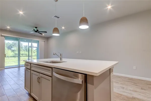 a kitchen with a sink cabinets and wooden floor
