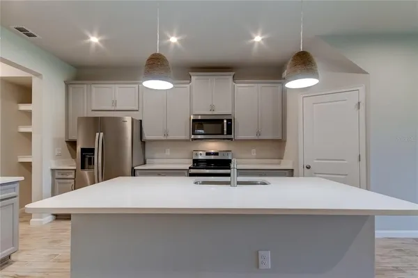 a kitchen with cabinets and stainless steel appliances