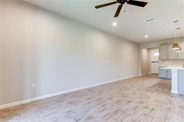 a view of a kitchen with a sink and dishwasher a refrigerator with wooden floor