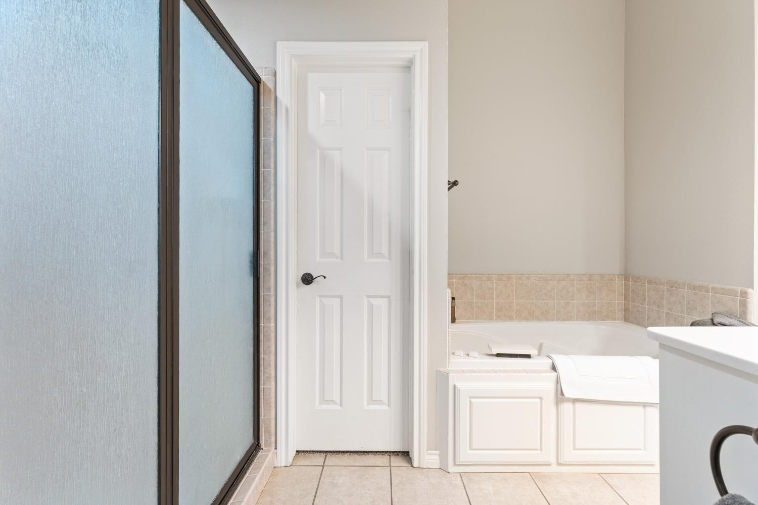 5614 100th Street Lubbock, TX 79424 - Photo 16 of 27 a bathroom with a sink a vanity and a mirror