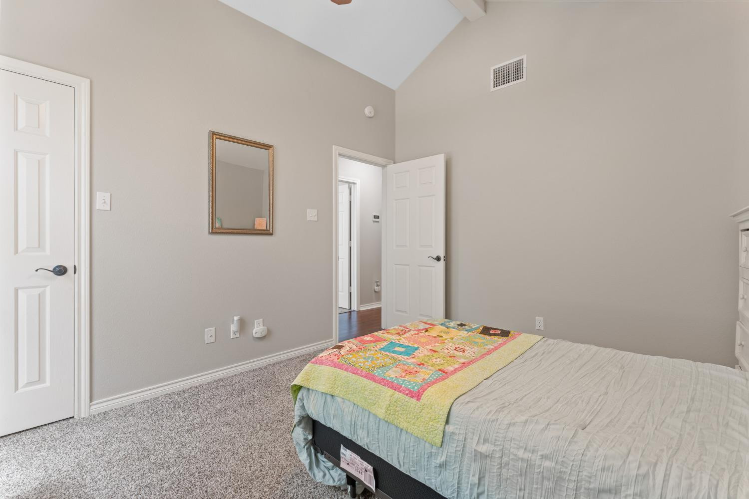 5614 100th Street Lubbock, TX 79424 - Photo 19 of 27 a bedroom with a bed and a table