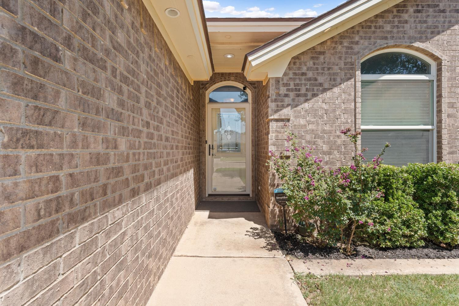 5614 100th Street Lubbock, TX 79424 - Photo 3 of 27 a view of a brick wall with a window