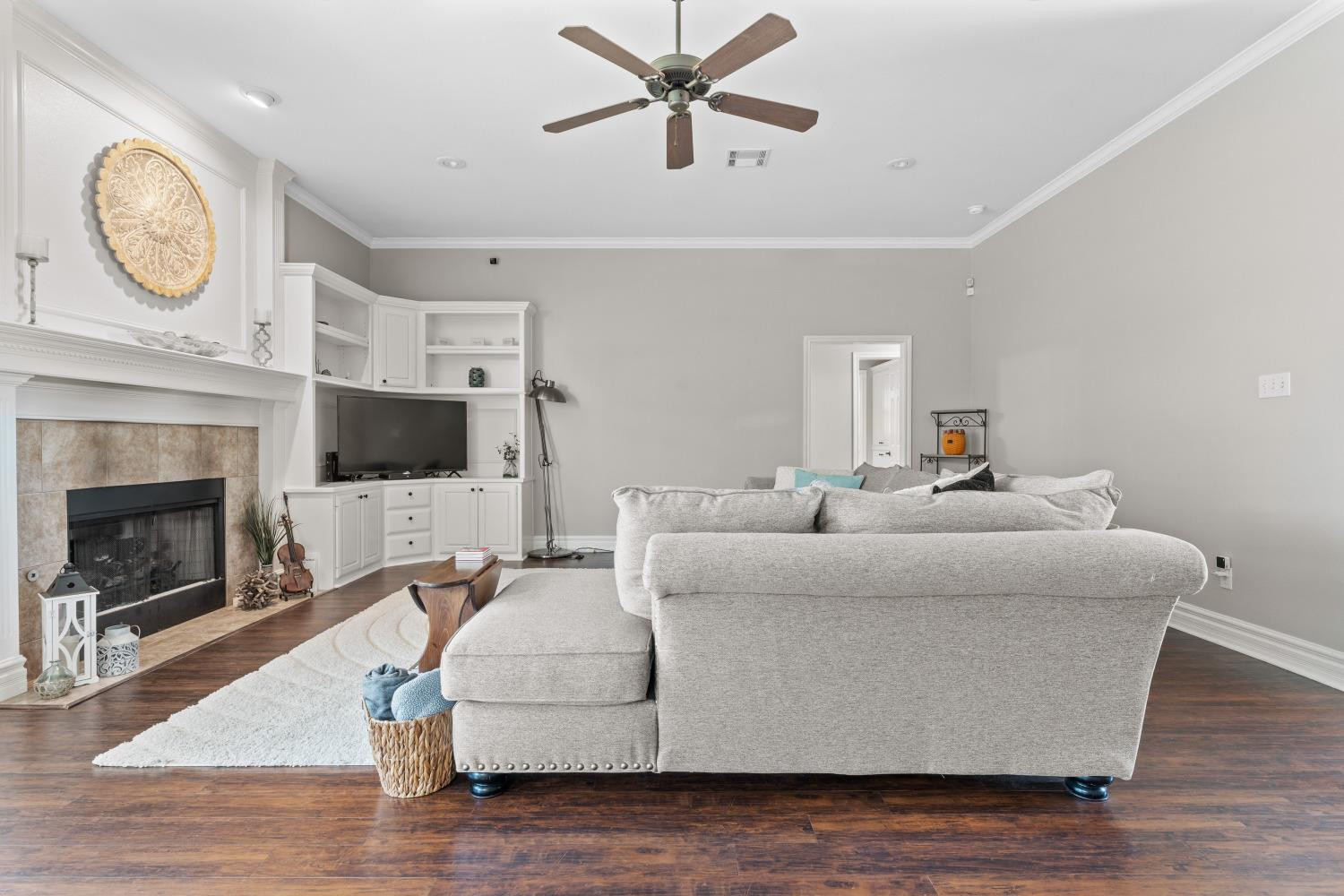 5614 100th Street Lubbock, TX 79424 - Photo 7 of 27 a living room with furniture a fireplace and a flat screen tv