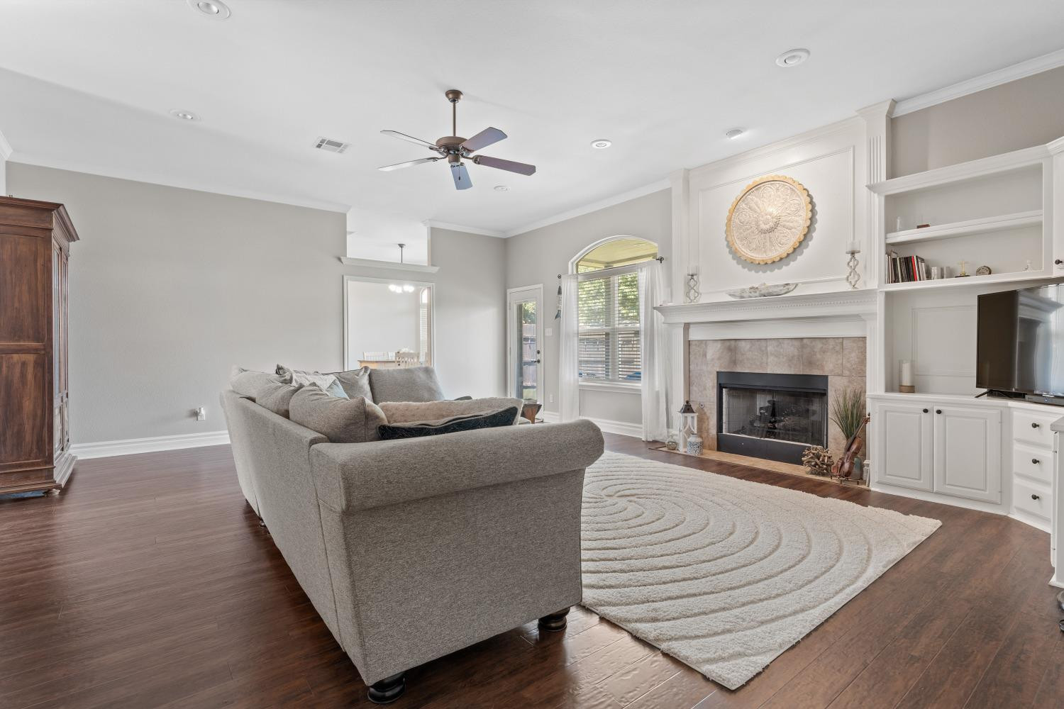 5614 100th Street Lubbock, TX 79424 - Photo 8 of 27 a living room with furniture a clock and a fireplace