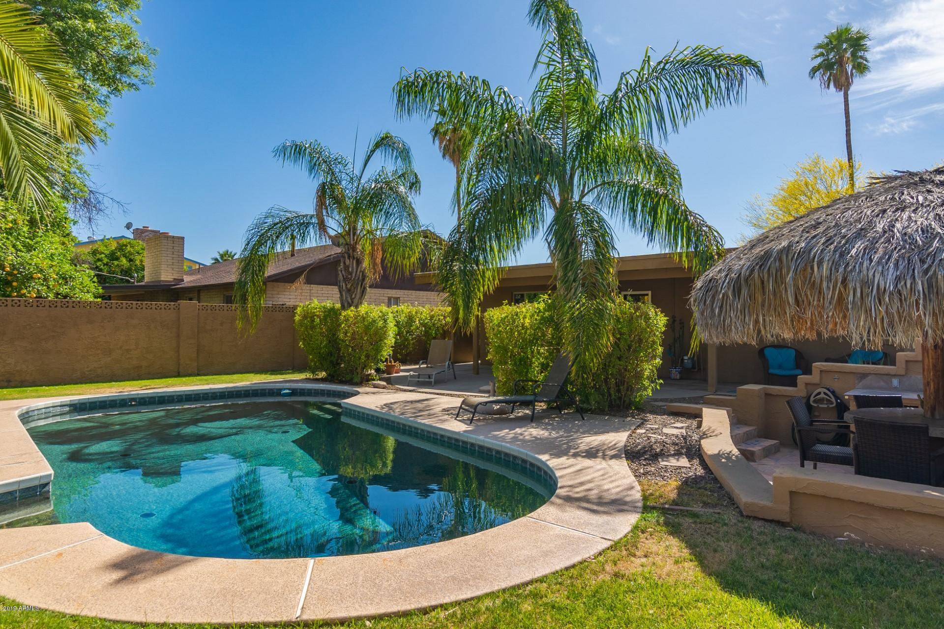 5319 North 15th Street Phoenix, AZ 85014 - Photo 1 of 33 a view of a backyard with plants and palm tree