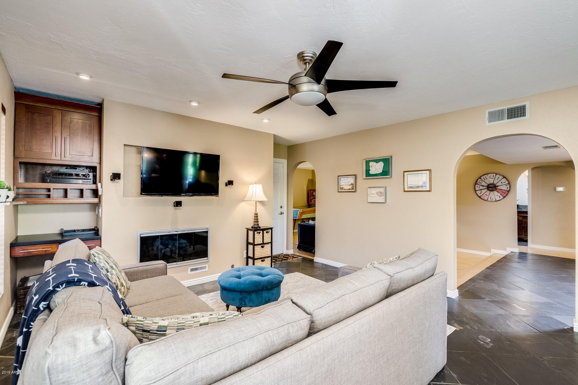 5319 North 15th Street Phoenix, AZ 85014 - Photo 11 of 33 a living room with furniture a fireplace and a flat screen tv