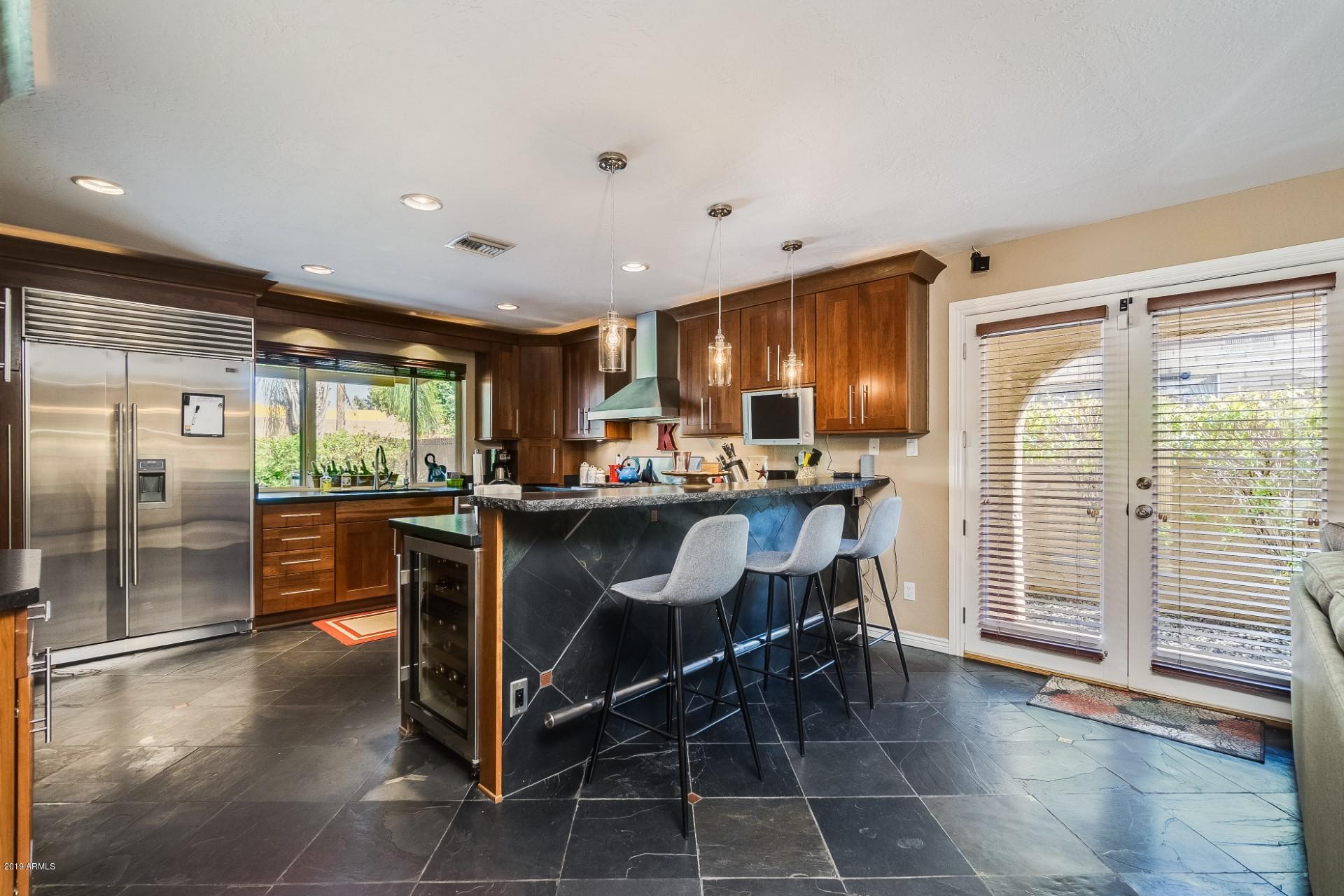 5319 North 15th Street Phoenix, AZ 85014 - Photo 12 of 33 a kitchen with stainless steel appliances granite countertop a refrigerator and a sink