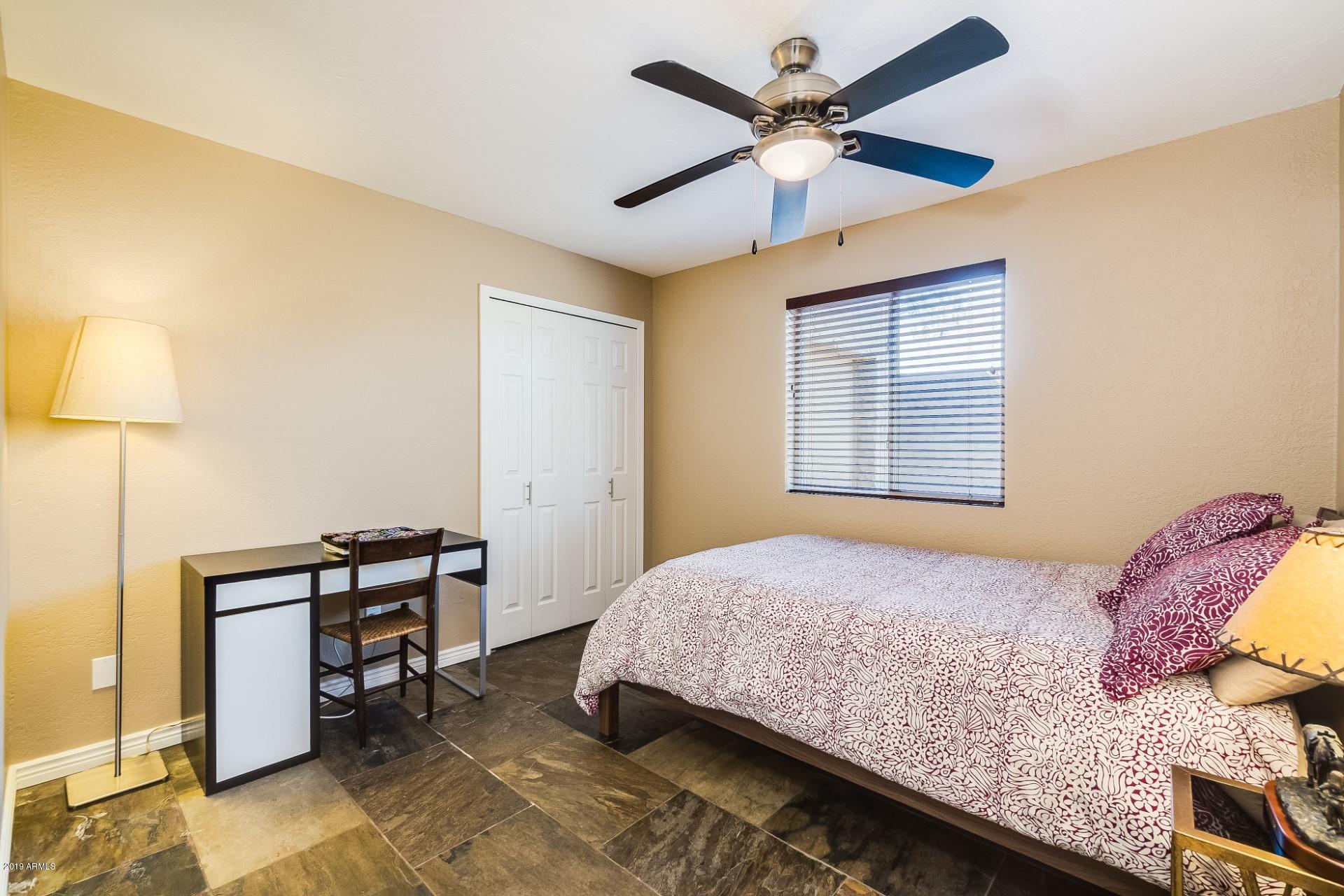 5319 North 15th Street Phoenix, AZ 85014 - Photo 25 of 33 a bedroom with a bed and a chandelier