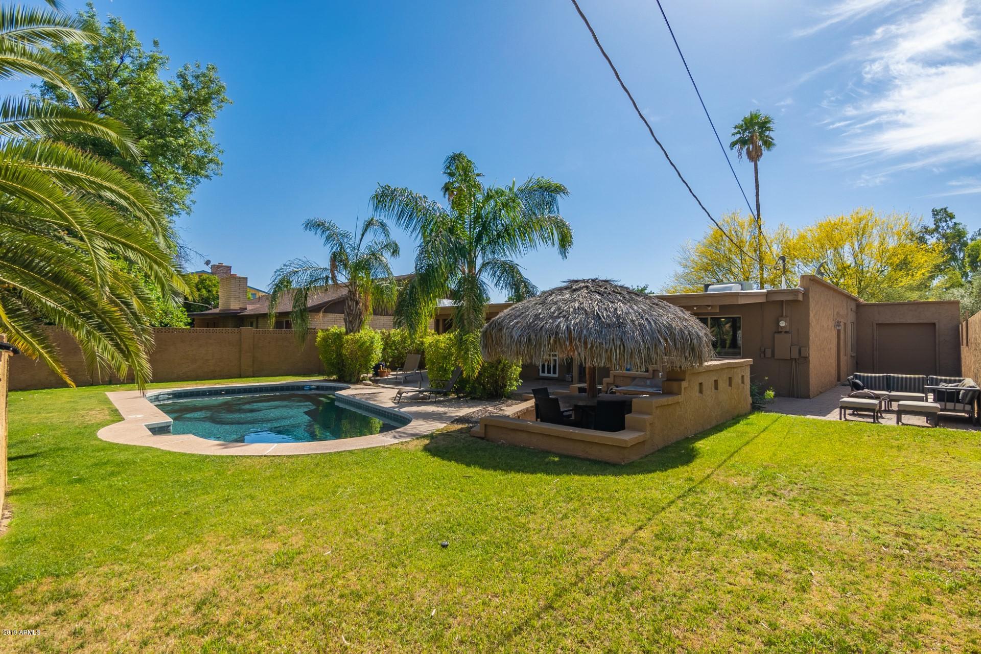 5319 North 15th Street Phoenix, AZ 85014 - Photo 32 of 33 a swimming pool with outdoor seating and yard
