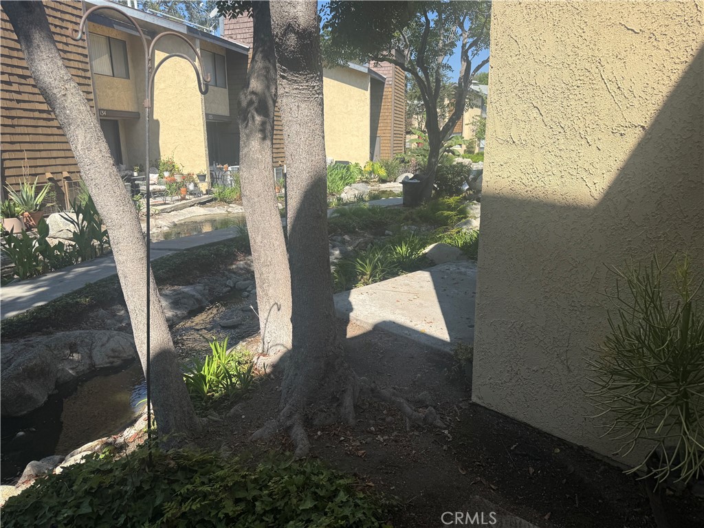 12750 Centralia Street, Unit 191 Lakewood, CA 90715 - Photo 13 of 38 a view of a porch with a table and chairs next to a yard