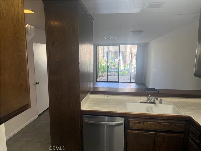 a room with a sink cabinets and a window