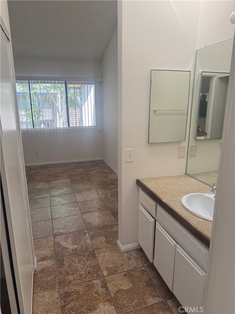12750 Centralia Street, Unit 191 Lakewood, CA 90715 - Photo 26 of 38 a bathroom with a granite countertop sink and a mirror