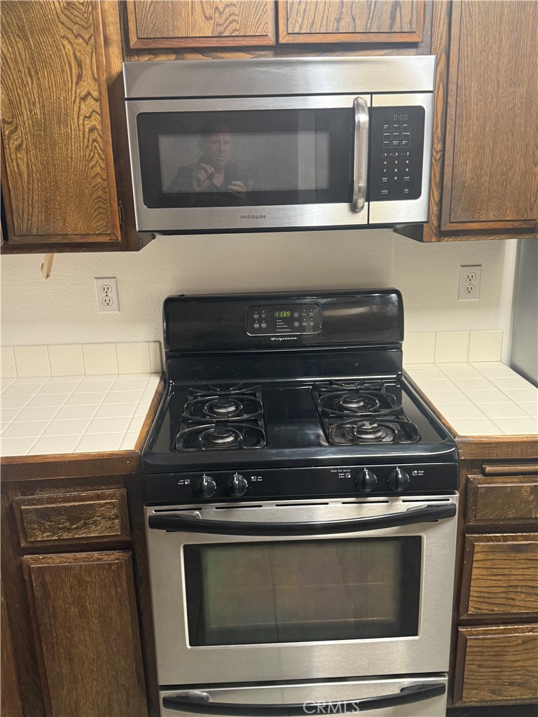 12750 Centralia Street, Unit 191 Lakewood, CA 90715 - Photo 36 of 38 a stove top oven sitting inside of a kitchen