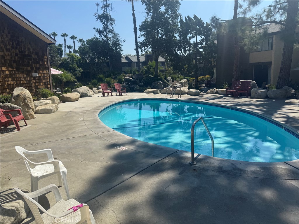 12750 Centralia Street, Unit 191 Lakewood, CA 90715 - Photo 8 of 38 a view of swimming pool with outdoor seating