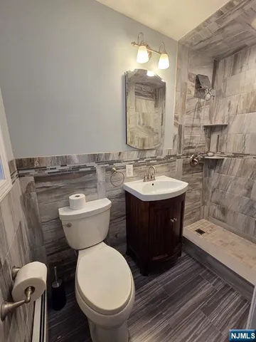 a bathroom with a toilet a sink and mirror