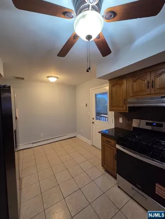 a kitchen with stainless steel appliances granite countertop a stove and a refrigerator