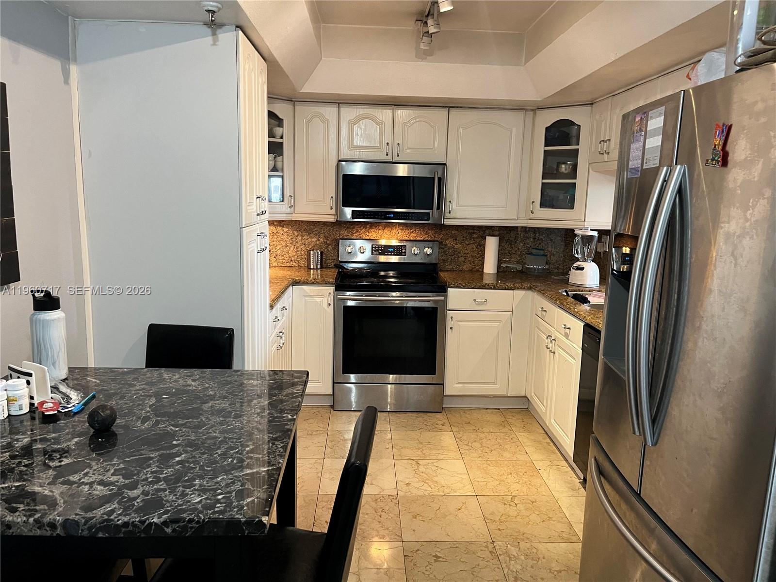 520 Brickell Key Drive, Unit A610 Miami, FL 33131 - Photo 4 of 10 a kitchen with stainless steel appliances granite countertop a refrigerator stove and microwave