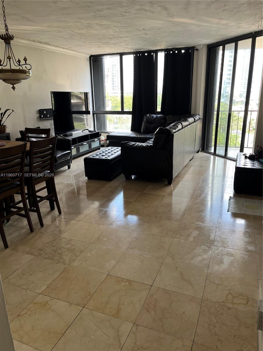 520 Brickell Key Drive, Unit A610 Miami, FL 33131 - Photo 5 of 10 a living room with patio furniture and a flat screen tv