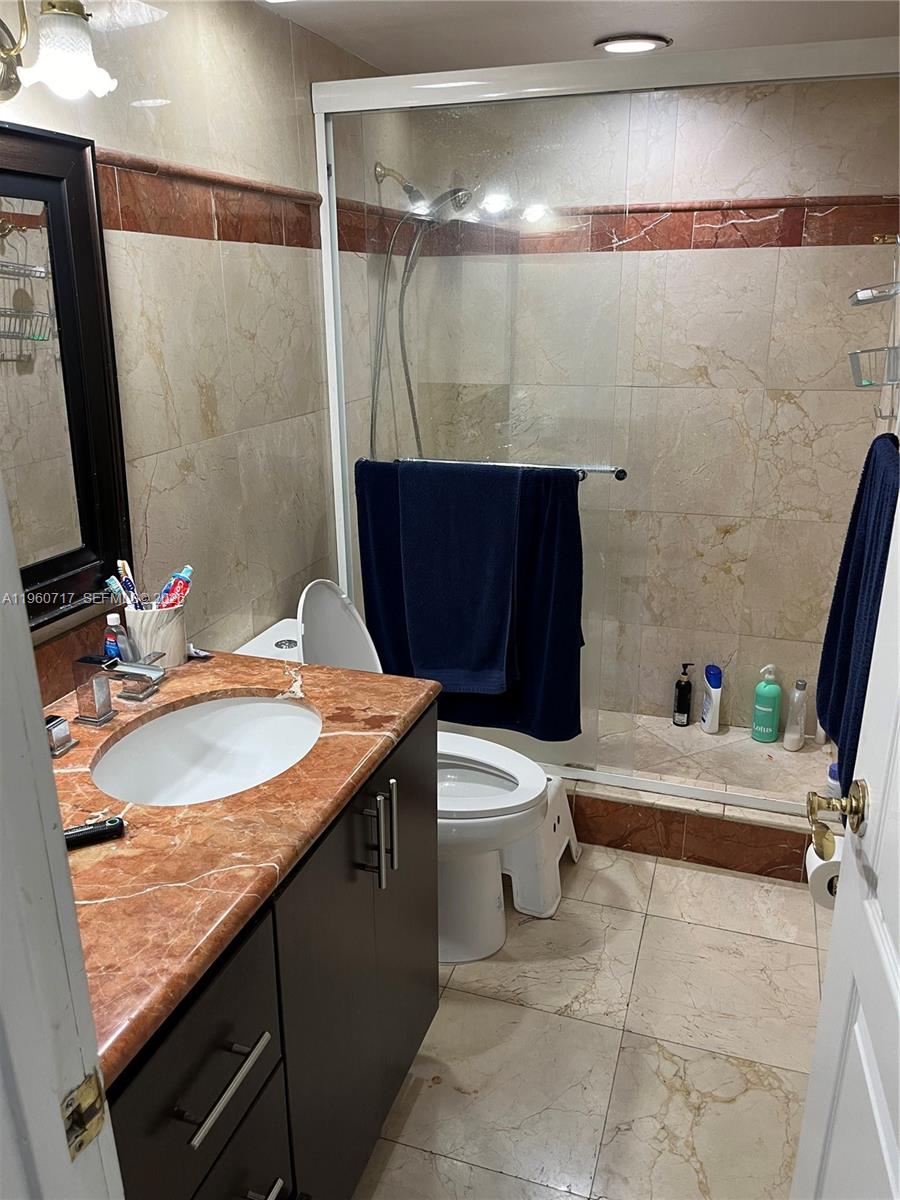 520 Brickell Key Drive, Unit A610 Miami, FL 33131 - Photo 8 of 10 a bathroom with a sink a toilet and shower