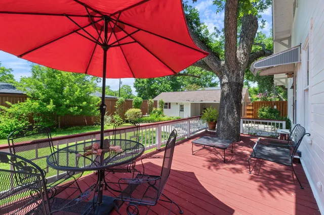 a view of a patio with a table chairs and a table