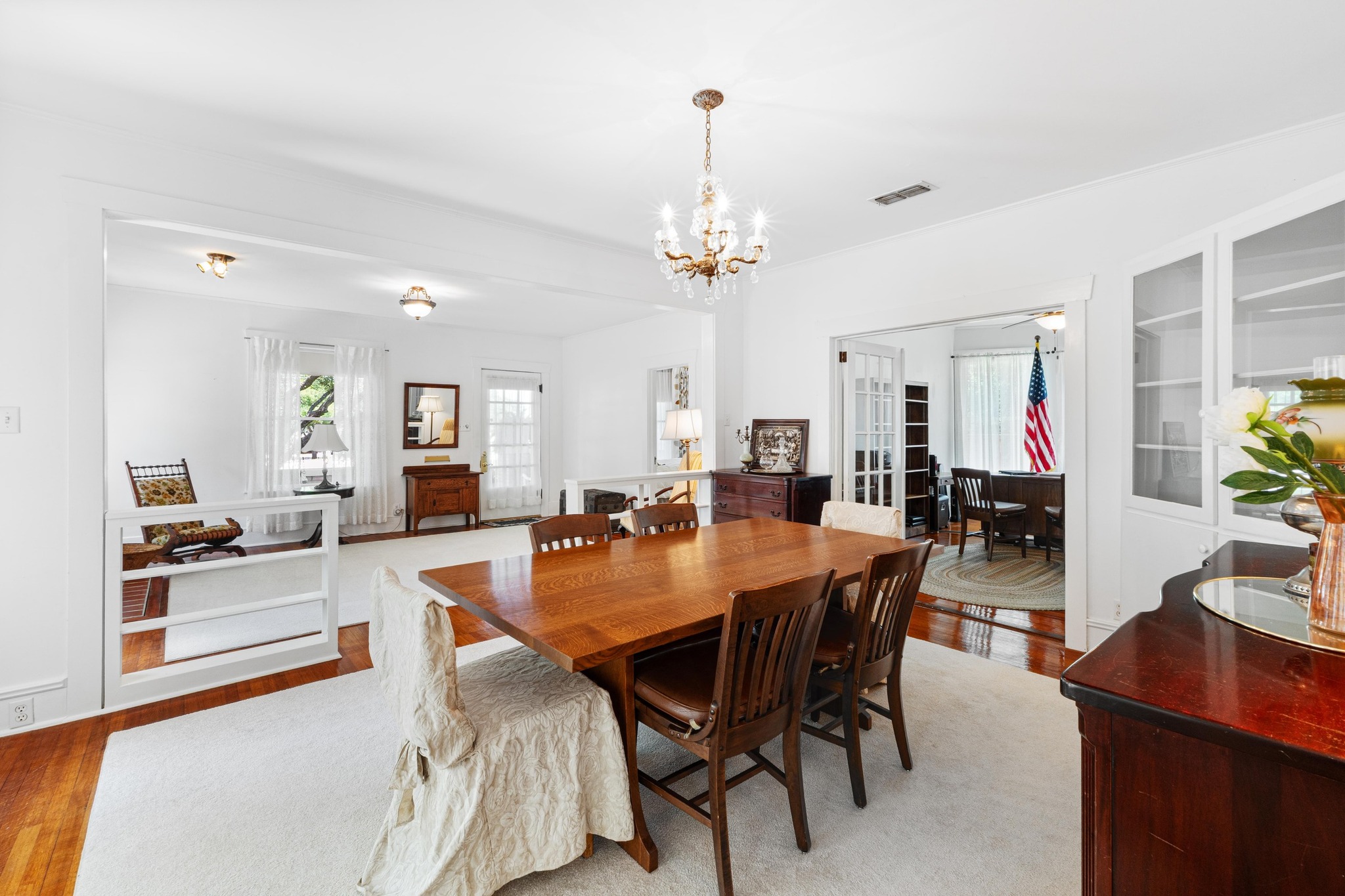 810 East University Avenue Georgetown, TX 78626 - Photo 10 of 38 a dining room with wooden floor a chandelier a wooden table and chairs