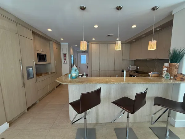 a large kitchen with a table and chairs