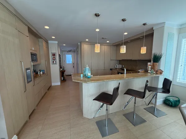 a kitchen with a sink and chairs