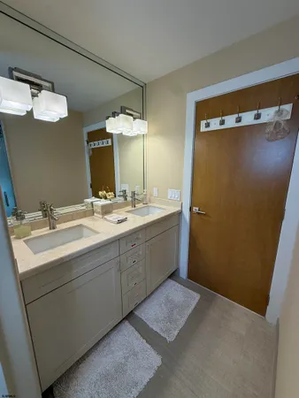 a bathroom with a double vanity sink and mirror