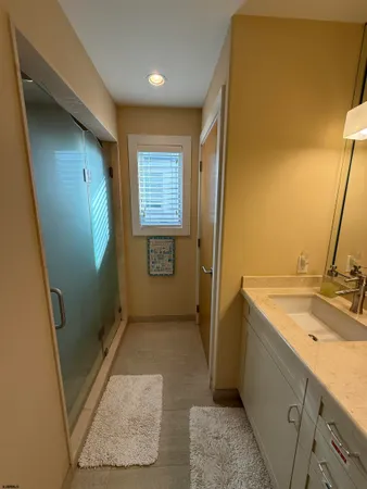 a bathroom with a sink a mirror and a shower