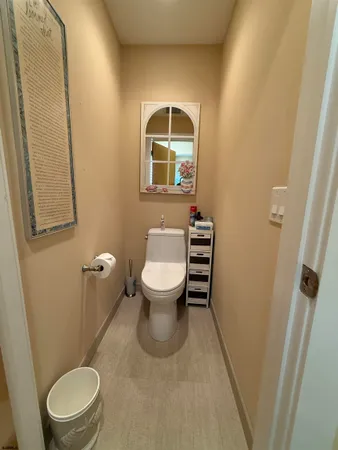 a bathroom with a toilet a sink and a mirror