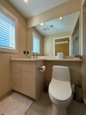 a bathroom with a toilet sink and mirror