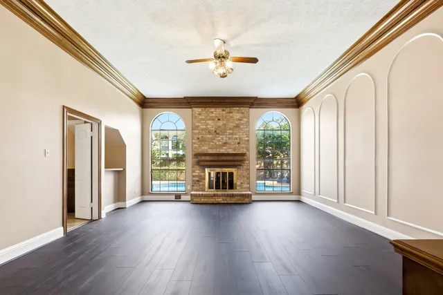 a living room with a fireplace furniture and a large window