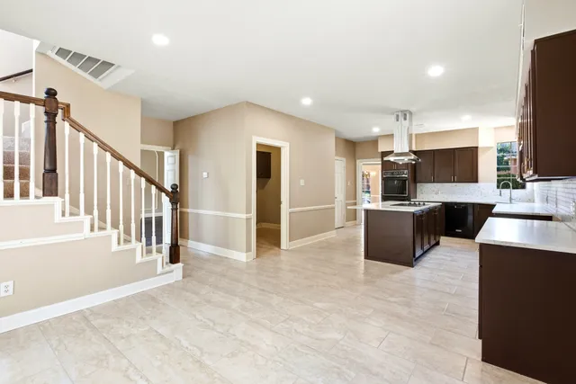 a view of a kitchen with a sink a microwave and cabinets