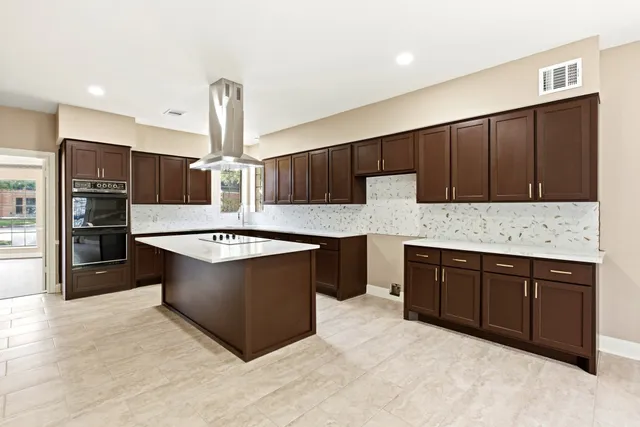 a kitchen with stainless steel appliances granite countertop a sink and a stove top oven