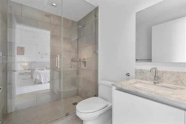a bathroom with a toilet sink and a shower
