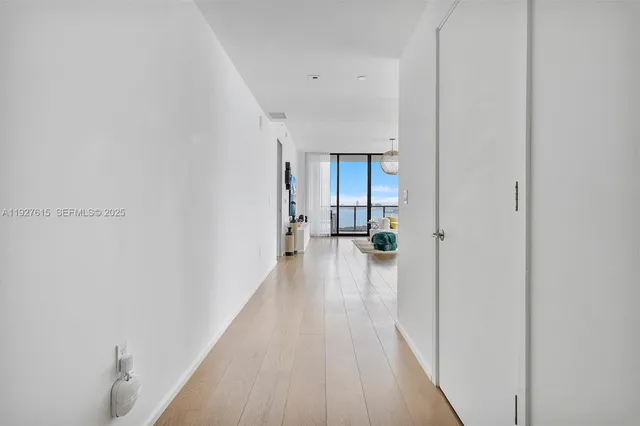 a view of a hallway with wooden floor
