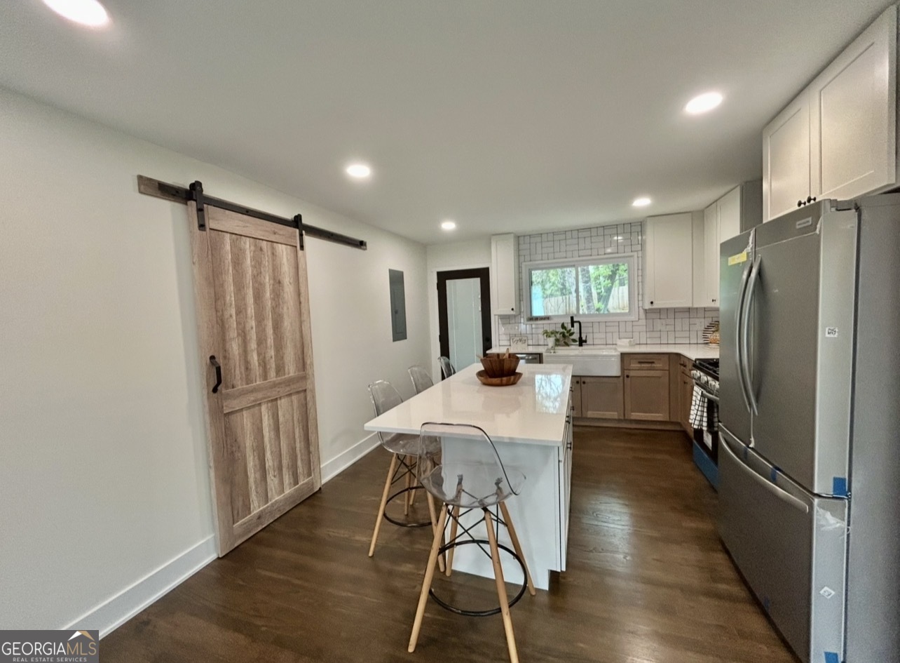 1742 Constitution Road Southeast Atlanta, GA 30316 - Photo 8 of 32 a kitchen with stainless steel appliances a refrigerator and wooden floor