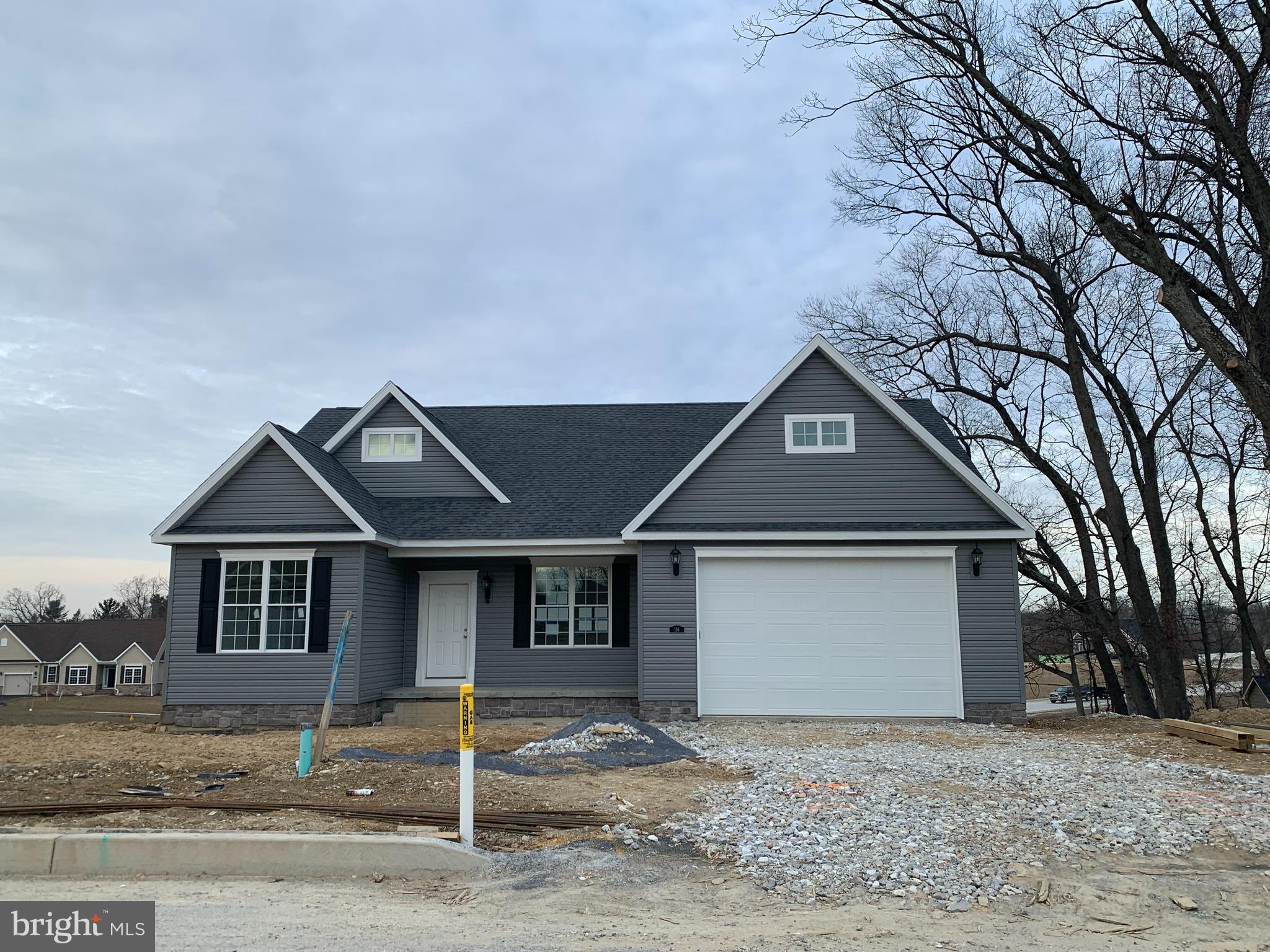 116 Quartz Ridge Road, Unit 32 Hanover, PA 17331 - Photo 2 of 2 a front view of a house with a yard and garage