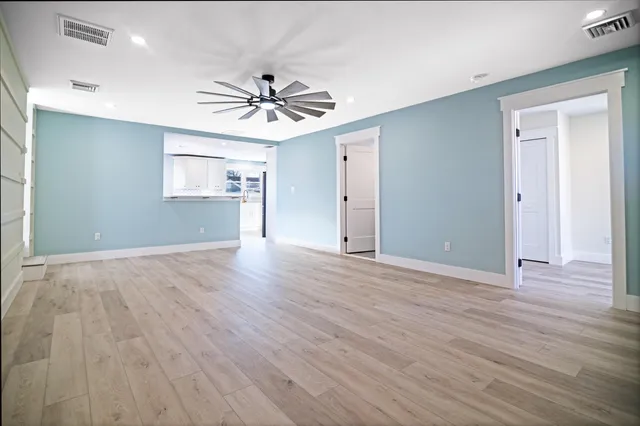 wooden floor in an empty room with a window