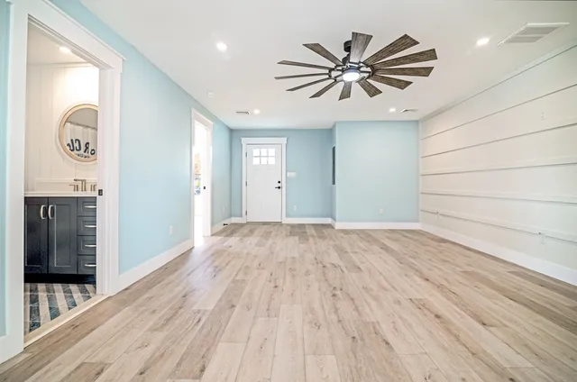 a view of a room with wooden floor and white walls
