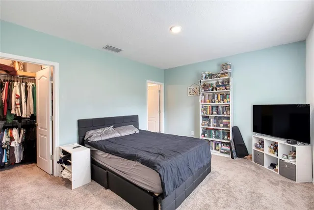 a living room with a flat screen tv and a book shelf