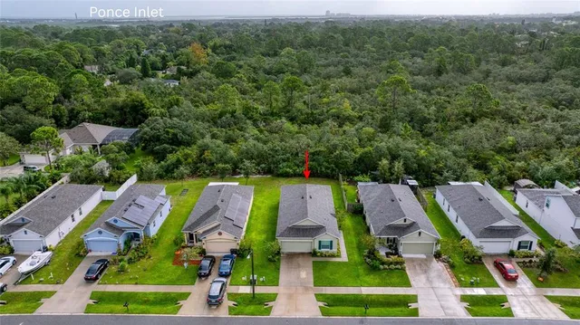 an aerial view of house with swimming pool outdoor seating and yard