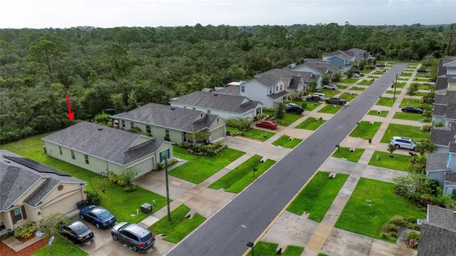an aerial view of multiple houses with a yard