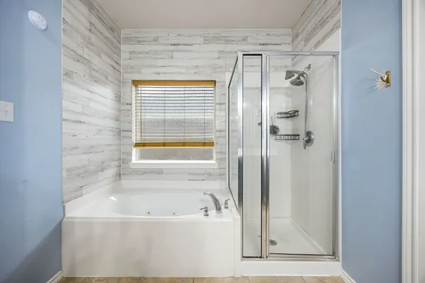 a bathroom with a bathtub and a shower