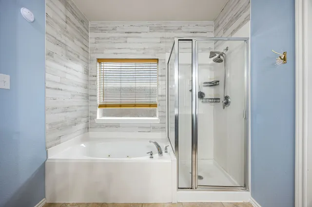 a bathroom with a bathtub and a shower