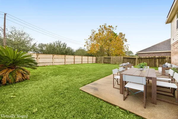 a view of a backyard with sitting area